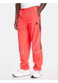 Adidas - adidas Spodnie dresowe Teamgeist adicolor JW5871 Czerwony Loose Fit. Kolor: czerwony. Materiał: syntetyk