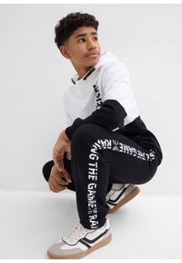 bonprix - Spodnie dresowe z czystej bawełny organicznej. Kolor: czarny. Materiał: bawełna, dresówka. Wzór: napisy #2