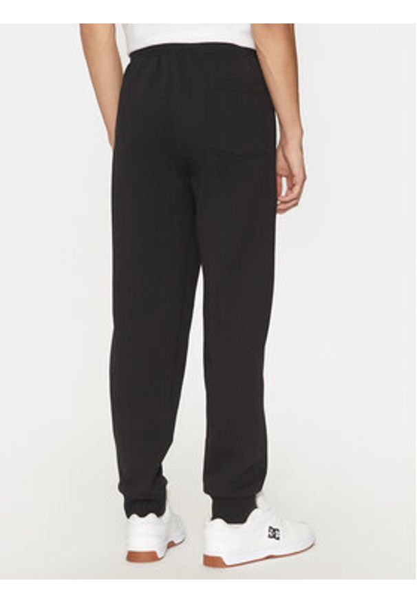 Champion Spodnie dresowe 220434 Czarny Loose Fit. Kolor: czarny. Materiał: bawełna