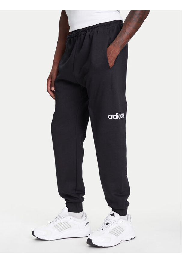 Adidas - adidas Spodnie dresowe Essentials Linear Fleece JN1786 Czarny Regular Fit. Kolor: czarny. Materiał: bawełna