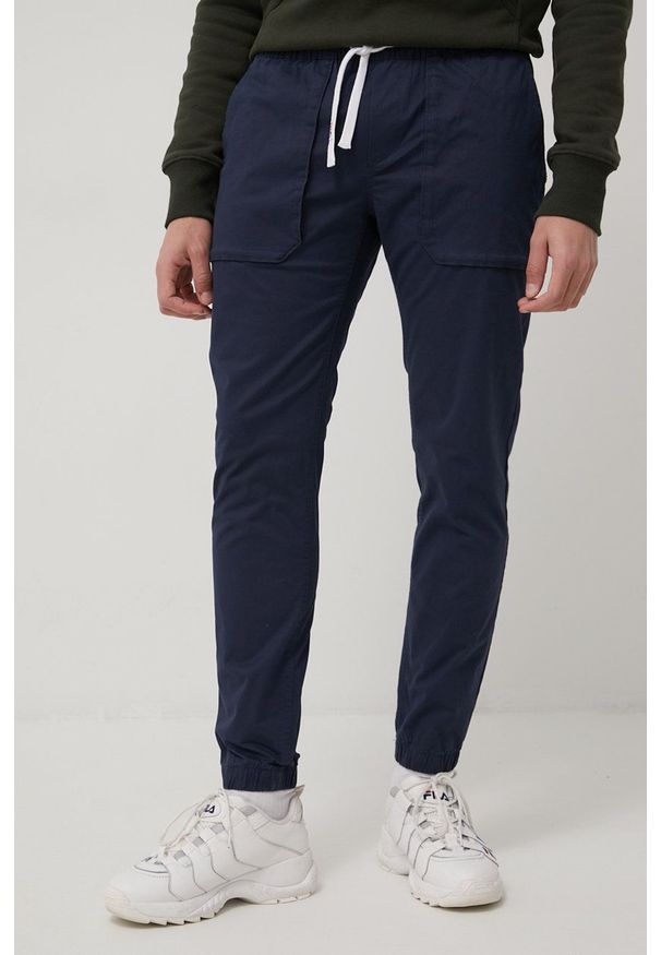 Tommy Jeans spodnie SCANTON męskie kolor granatowy joggery. Kolor: niebieski. Materiał: materiał, bawełna, tkanina. Wzór: gładki