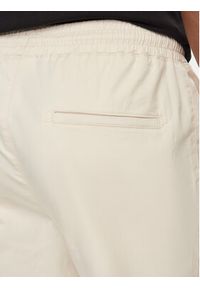 Champion Spodnie dresowe 219865 Beżowy Custom Fit. Kolor: beżowy. Materiał: bawełna