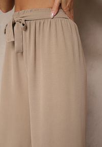 Renee - Ciemnobeżowe Szerokie Spodnie High Waist z Wiązaniem w Talii Reivaritta. Okazja: na co dzień, na spotkanie biznesowe, do pracy. Stan: podwyższony. Kolor: beżowy. Styl: biznesowy, elegancki, casual