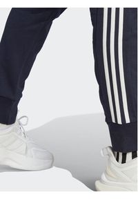 Adidas - adidas Spodnie dresowe Essentials French Terry Tapered Cuff 3-Stripes Joggers IC9406 Niebieski Regular Fit. Kolor: niebieski. Materiał: bawełna #6