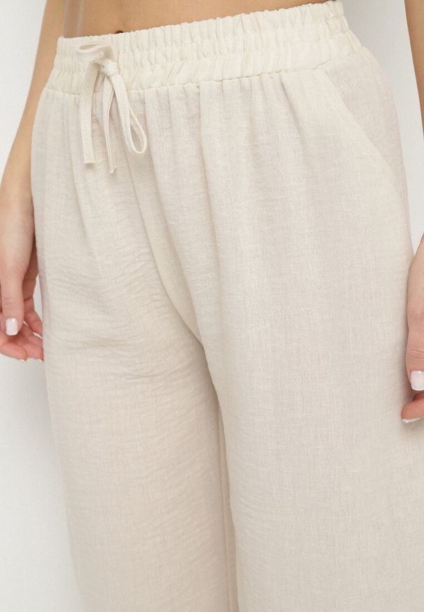 Born2be - Jasnobeżowe Szerokie Spodnie z Wysokim Stanem i Wiązaniem Edirwenna. Okazja: na spotkanie biznesowe, na spacer. Stan: podwyższony. Kolor: beżowy. Styl: biznesowy, klasyczny