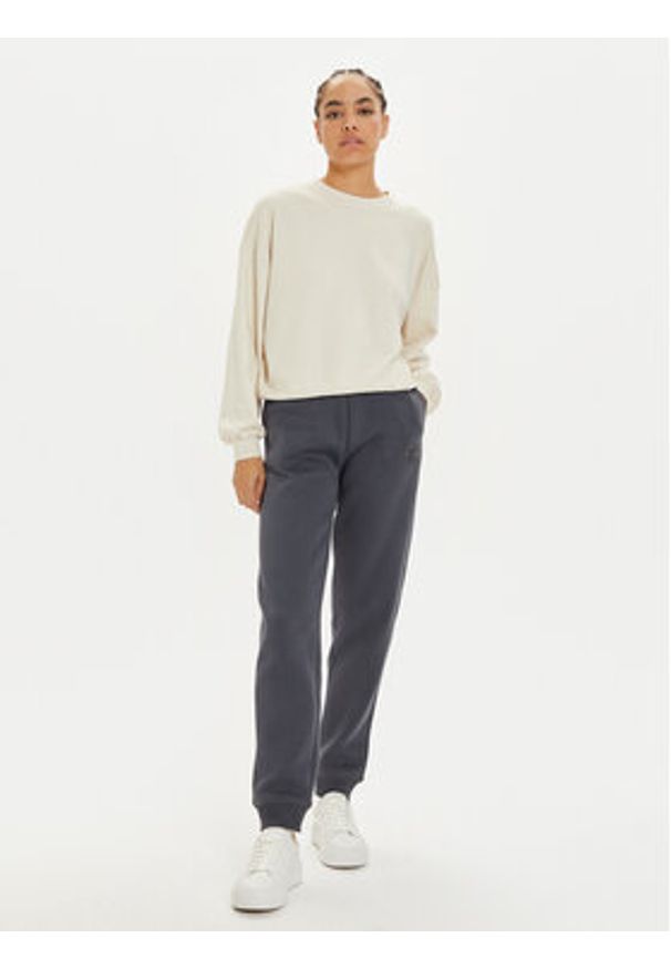 Calvin Klein Jeans Spodnie dresowe Monologo J20J223590 Szary Relaxed Fit. Kolor: szary. Materiał: syntetyk, bawełna