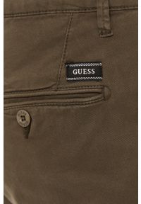 Guess - Spodnie. Kolor: oliwkowy. Materiał: tkanina, bawełna, materiał, elastan. Wzór: gładki #3