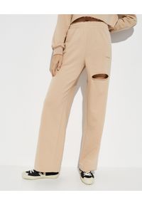 LA MANIA - Beżowe spodnie dresowe Clyde. Kolor: beżowy. Materiał: dresówka. Wzór: napisy