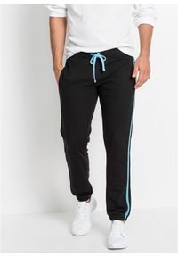 bonprix - Spodnie sportowe z kontrastowymi elementami. Kolor: czarny. Materiał: dresówka. Styl: sportowy #1