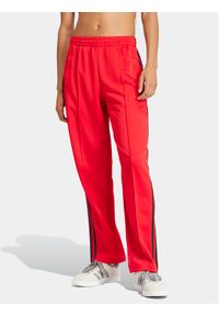Adidas - adidas Spodnie dresowe adicolor Classics SST IM9809 Czerwony Loose Fit. Kolor: czerwony. Materiał: bawełna