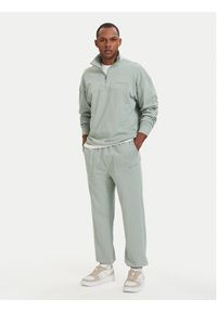 TOMMY HILFIGER - Tommy Hilfiger Spodnie dresowe Essential UM0UM03911 Zielony jasny Relaxed Fit. Kolor: zielony. Materiał: bawełna #5