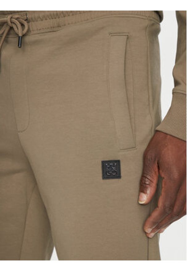 Hugo - HUGO Spodnie dresowe Dimacs 50533695 Brązowy Relaxed Fit. Kolor: brązowy. Materiał: bawełna