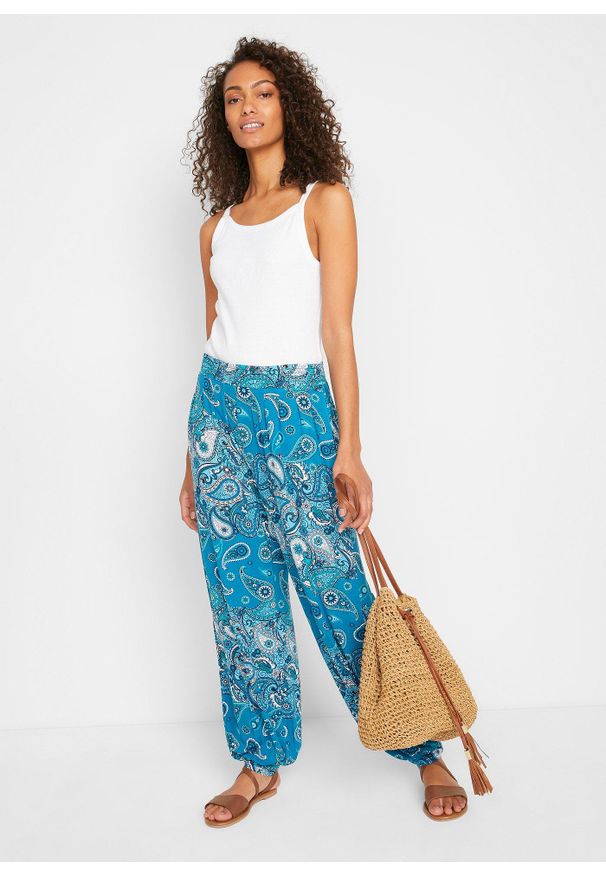 bonprix - Dżersejowe spodnie haremki z lejącej mieszanki wiskozy. Kolor: niebieski. Materiał: jersey, wiskoza. Wzór: paisley, nadruk