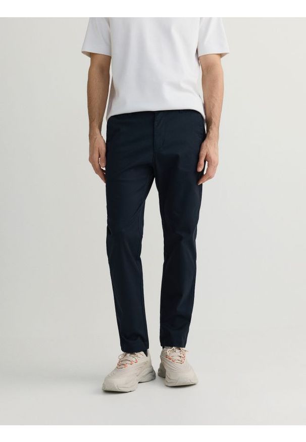 Reserved - Spodnie chino slim fit - granatowy. Kolor: niebieski. Materiał: tkanina, bawełna
