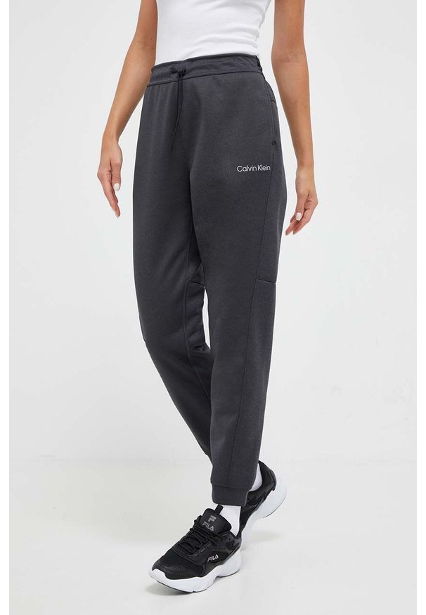 Calvin Klein Performance spodnie treningowe kolor szary melanżowe. Stan: podwyższony. Kolor: szary. Wzór: melanż