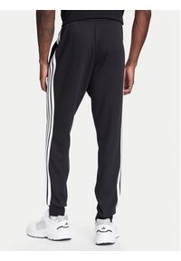 Adidas - adidas Spodnie dresowe Essentials 3-Stripes JD1861 Czarny Regular Fit. Kolor: czarny. Materiał: bawełna