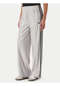 Adidas - adidas Spodnie dresowe Metallic Firebird KS9973 Szary jasny Wide Leg. Kolor: szary. Materiał: syntetyk #1