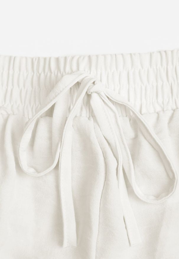 Renee - Jasnobeżowe Szorty High Waist z Wiskozą i Bawełną Ozdobione Koronką i Gumką w Pasie Tadea. Stan: podwyższony. Kolor: beżowy. Materiał: wiskoza, bawełna, koronka. Wzór: aplikacja, koronka. Sezon: lato. Styl: elegancki, klasyczny