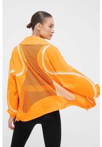 Adidas by Stella McCartney - adidas by Stella McCartney wiatrówka TruePace kolor pomarańczowy przejściowa oversize. Kolor: pomarańczowy. Materiał: materiał #1