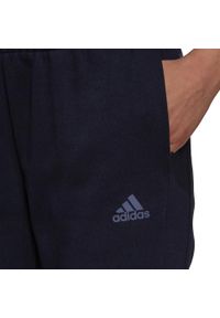 Adidas - Spodnie adidas Essentials 3-Stripes W H07806. Kolor: niebieski