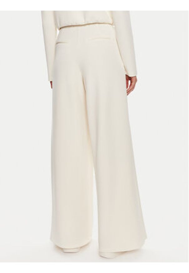 Guess Spodnie dresowe Olympe V4YB07 KCAY2 Beżowy Relaxed Fit. Kolor: beżowy. Materiał: syntetyk