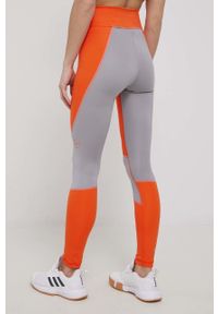 Adidas by Stella McCartney - adidas by Stella McCartney legginsy treningowe HD9109 damskie kolor pomarańczowy wzorzyste. Kolor: pomarańczowy. Materiał: skóra, poliester, dzianina, materiał. Wzór: ażurowy, ze splotem