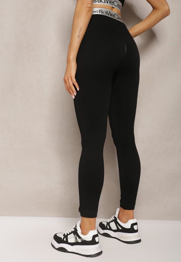 Renee - Czarne Sportowe Legginsy Elastyczne z Ozdobną Szeroką Gumą w Pasie Larnode. Okazja: na co dzień. Kolor: czarny. Materiał: guma. Styl: sportowy