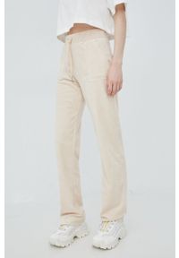 Juicy Couture spodnie dresowe damskie kolor beżowy gładkie. Stan: podwyższony. Kolor: beżowy. Materiał: dresówka. Wzór: gładki