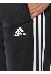 Adidas - adidas Spodnie dresowe Essentials Warm-Up 3-Stripes H48451 Czarny Regular Fit. Kolor: czarny. Materiał: syntetyk