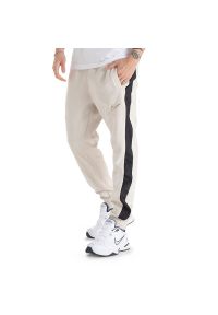 Spodnie Nike Sportswear Fleece FN0246-104 - beżowe. Kolor: beżowy. Materiał: dresówka, bawełna, materiał, poliester
