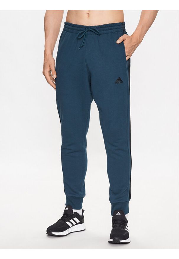 Adidas - adidas Spodnie dresowe Essentials French Terry Tapered Cuff 3-Stripes Joggers IJ8698 Turkusowy Regular Fit. Kolor: turkusowy. Materiał: bawełna, dresówka