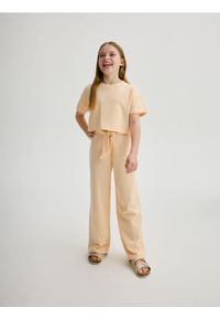 Reserved - Bawełniane spodnie - jasnopomarańczowy. Kolor: pomarańczowy. Materiał: bawełna #1