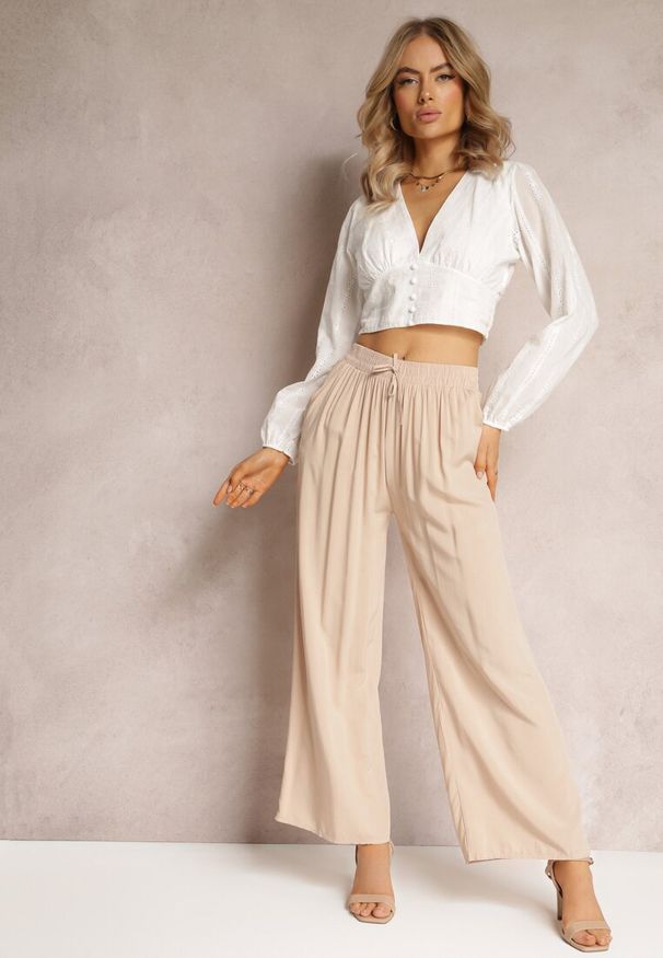 Renee - Beżowe Szerokie Spodnie z Gumką i Wiązaniem w Pasie Gamina. Kolor: beżowy. Sezon: wiosna, lato
