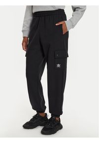 Adidas - adidas Spodnie dresowe Essentials IT7576 Czarny Loose Fit. Kolor: czarny. Materiał: bawełna, syntetyk #1