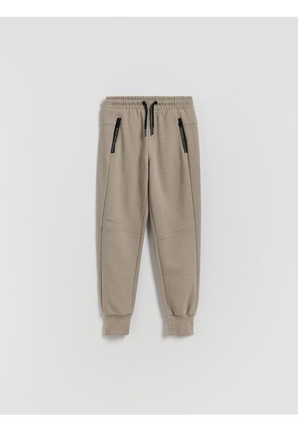 Reserved - Bawełniane spodnie jogger - beżowy. Kolor: beżowy. Materiał: bawełna