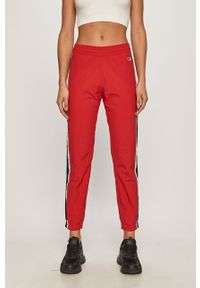 Champion - Spodnie. Kolor: czerwony. Materiał: tkanina, poliester, poliamid. Wzór: gładki #1