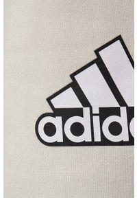 Adidas - adidas spodnie bawełniane HC9175 damskie kolor beżowy z nadrukiem. Kolor: beżowy. Materiał: bawełna. Wzór: nadruk #2