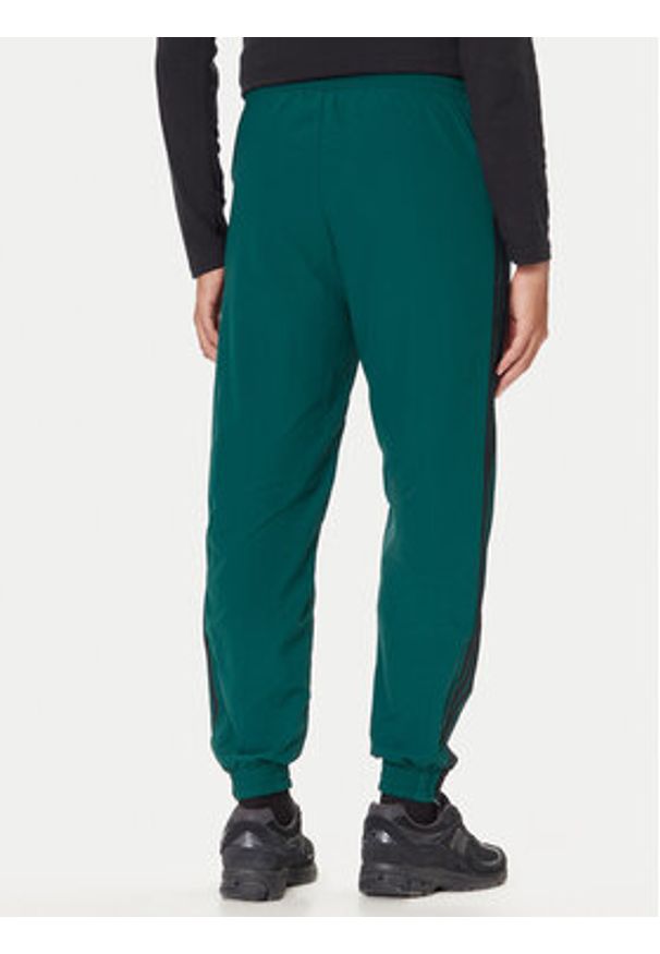 Adidas - adidas Spodnie dresowe adicolor Woven Firebird JY1335 Zielony Regular Fit. Kolor: zielony. Materiał: syntetyk