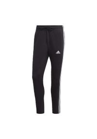 Adidas - Essentials Single Jersey Tapered Open Hem 3-Stripes Pants. Kolor: biały, wielokolorowy, czarny. Materiał: jersey
