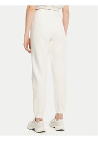 Tommy Jeans Spodnie dresowe Badge DW0DW20679 Écru Regular Fit. Materiał: bawełna