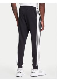 Adidas - adidas Spodnie dresowe Essential 3-Stripes JD1881 Czarny Regular Fit. Kolor: czarny. Materiał: bawełna, syntetyk #2