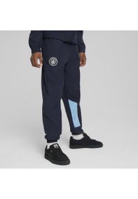 Puma - Młodzieżowe spodnie Manchester City ftblARCHIVE PUMA Navy Team Light Blue. Kolor: niebieski. Materiał: dresówka. Sport: piłka nożna