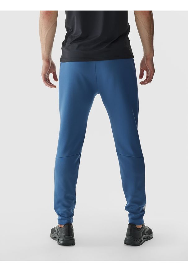 4f - 4F Spodnie treningowe szybkoschnące męskie - niebieskie 3XL. Kolor: niebieski. Materiał: materiał, dzianina, syntetyk, włókno, elastan. Wzór: jednolity, ze splotem. Sport: fitness