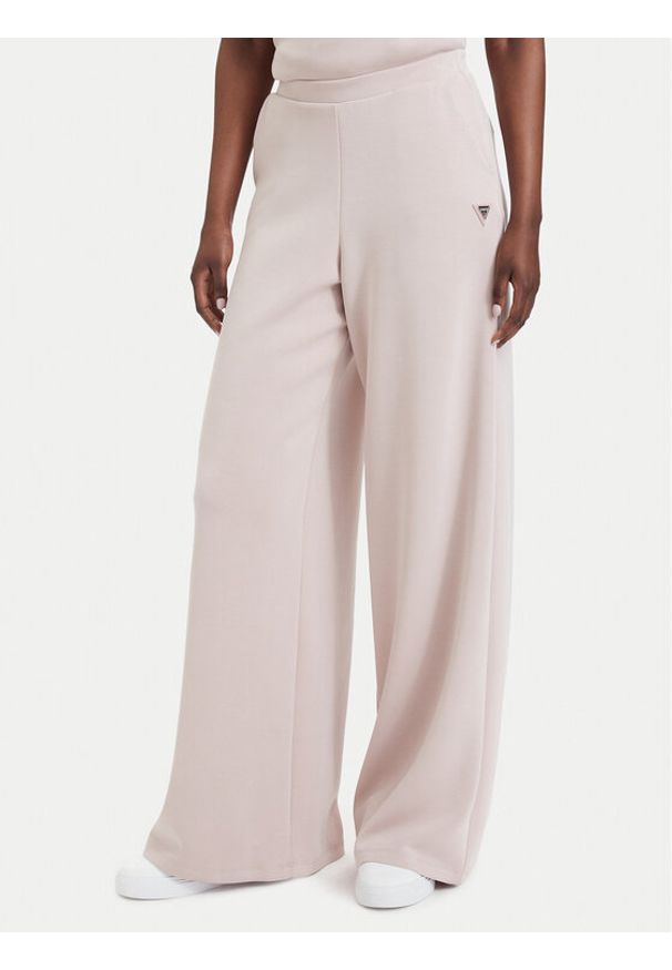 Guess Spodnie dresowe V4YB07 KCAY2 Różowy jasny Relaxed Fit. Kolor: różowy. Materiał: syntetyk