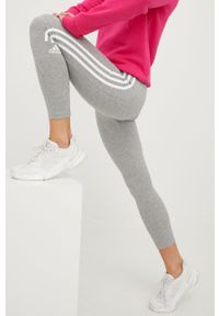 Adidas - adidas legginsy damskie kolor szary z nadrukiem. Kolor: szary. Materiał: materiał. Wzór: nadruk #1