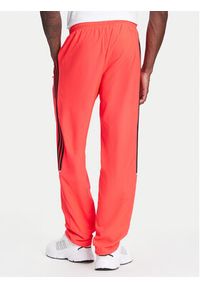 Adidas - adidas Spodnie dresowe Teamgeist adicolor JW5871 Czerwony Loose Fit. Kolor: czerwony. Materiał: syntetyk