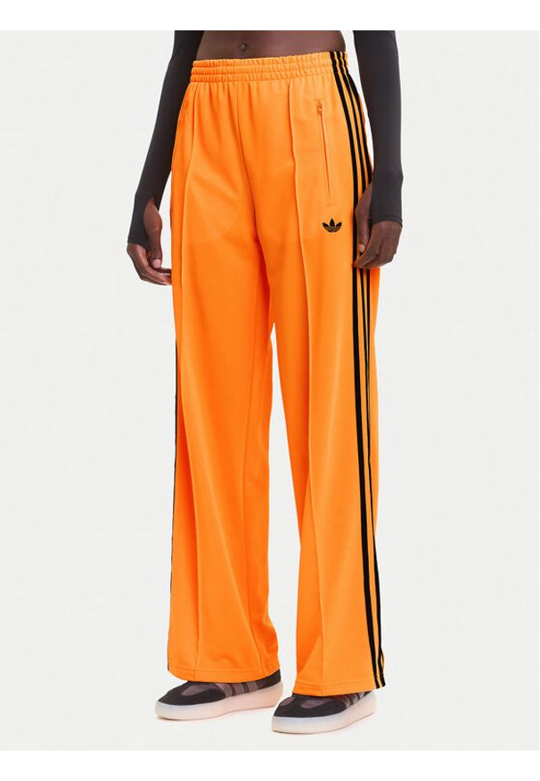 Adidas - adidas Spodnie dresowe adicolor Classic Firebird JY2694 Żółty Loose Fit. Kolor: żółty. Materiał: syntetyk