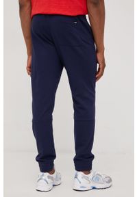 New Balance spodnie dresowe MP21900PGM męskie kolor granatowy z nadrukiem. Kolor: niebieski. Materiał: dresówka. Wzór: nadruk #3