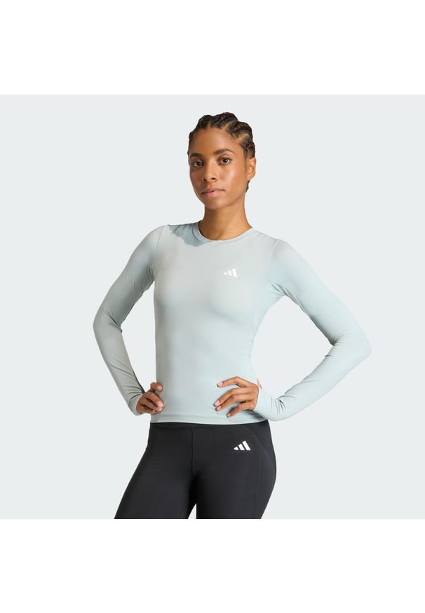 Adidas - Koszulka Power Essentials Workout Contour Long Sleeve. Kolor: zielony. Długość rękawa: długi rękaw. Technologia: ClimaCool (Adidas). Długość: długie. Sport: fitness
