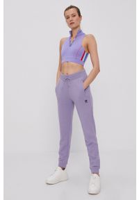 adidas Originals - Spodnie. Kolor: fioletowy. Materiał: tkanina. Wzór: gładki